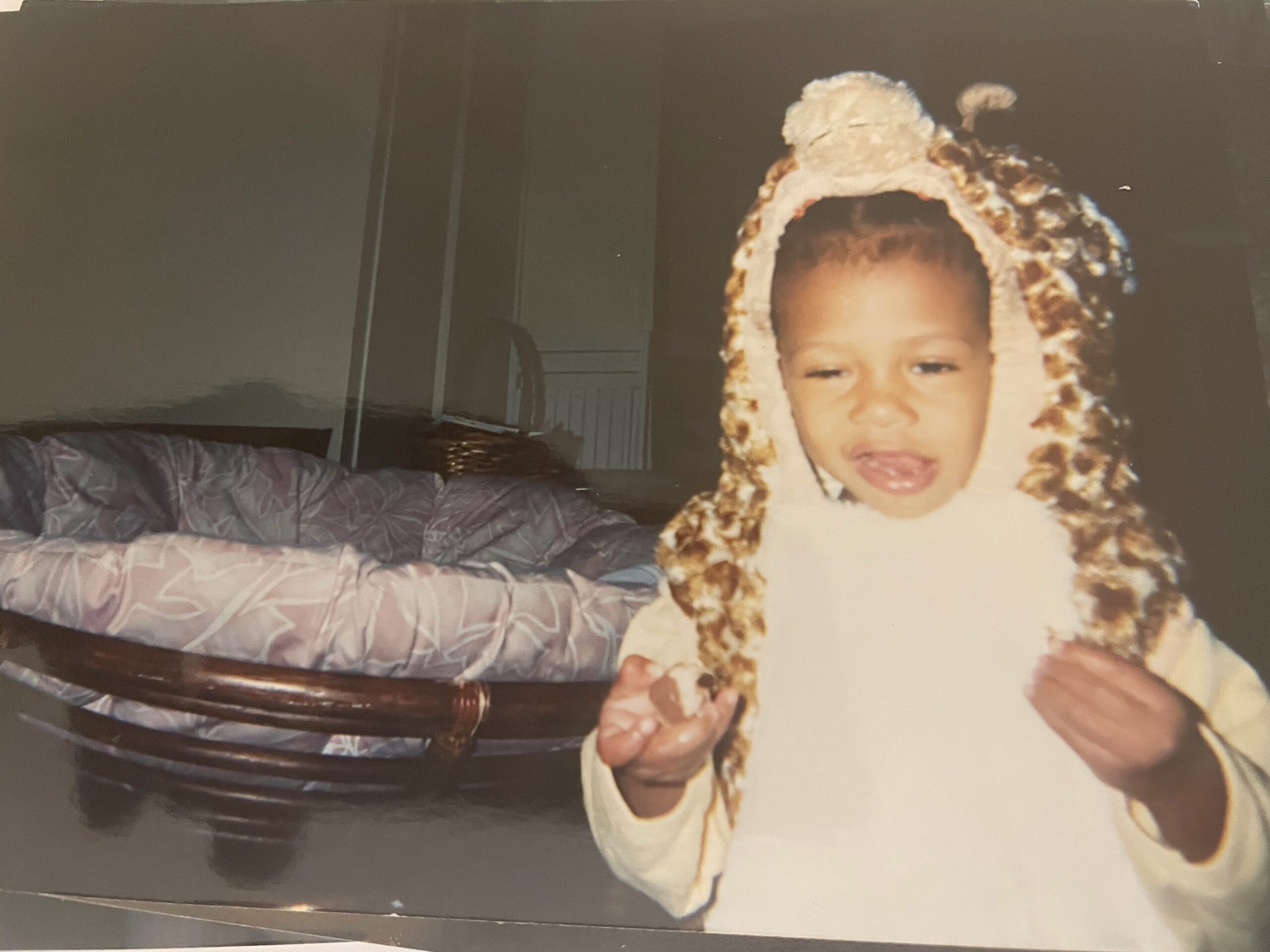 Faded photo of a young Black child in a lion costume